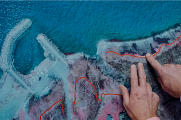a hand pointing at a map