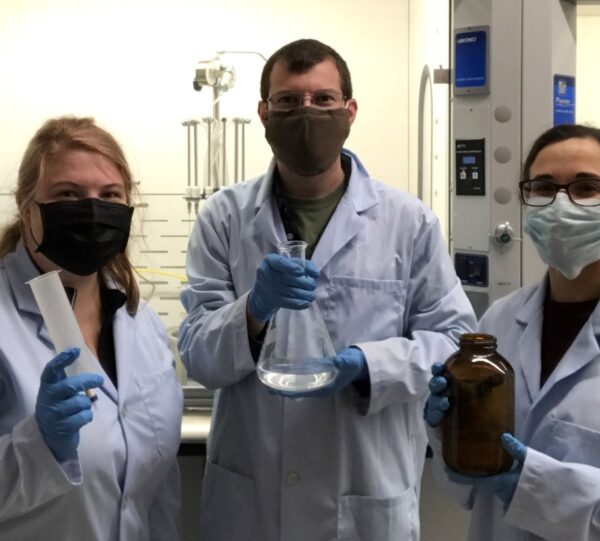 a group of people wearing lab coats and gloves