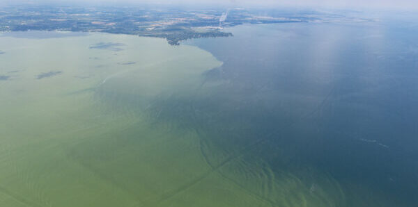 a body of water with clouds above it