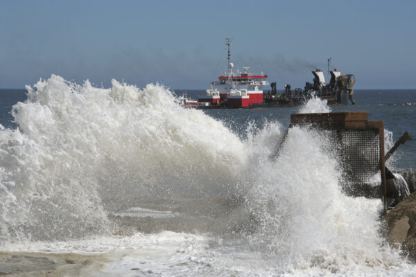 a large wave crashing into a boat