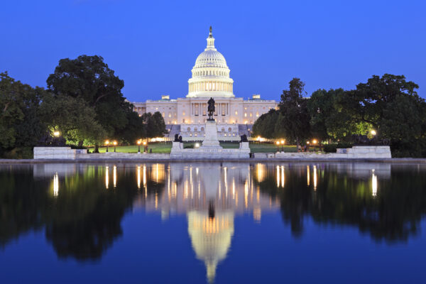 US Capitol illuminated at dusk in Washington DC with nice reflections into the water