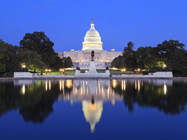 US Capitol illuminated at dusk in Washington DC with nice reflections into the water